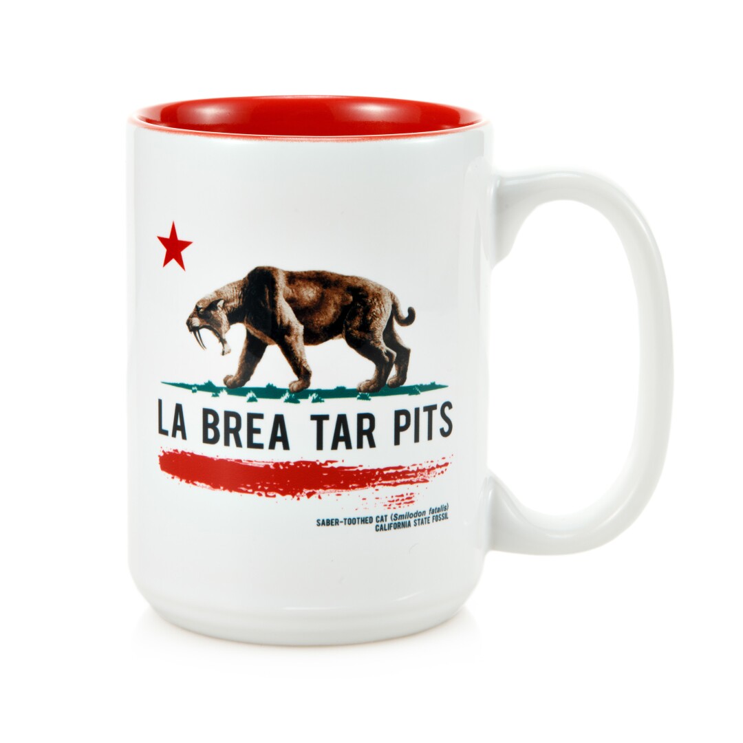 A ceramic mug with a saber-toothed tiger and the words "La Brea Tar Pits"
