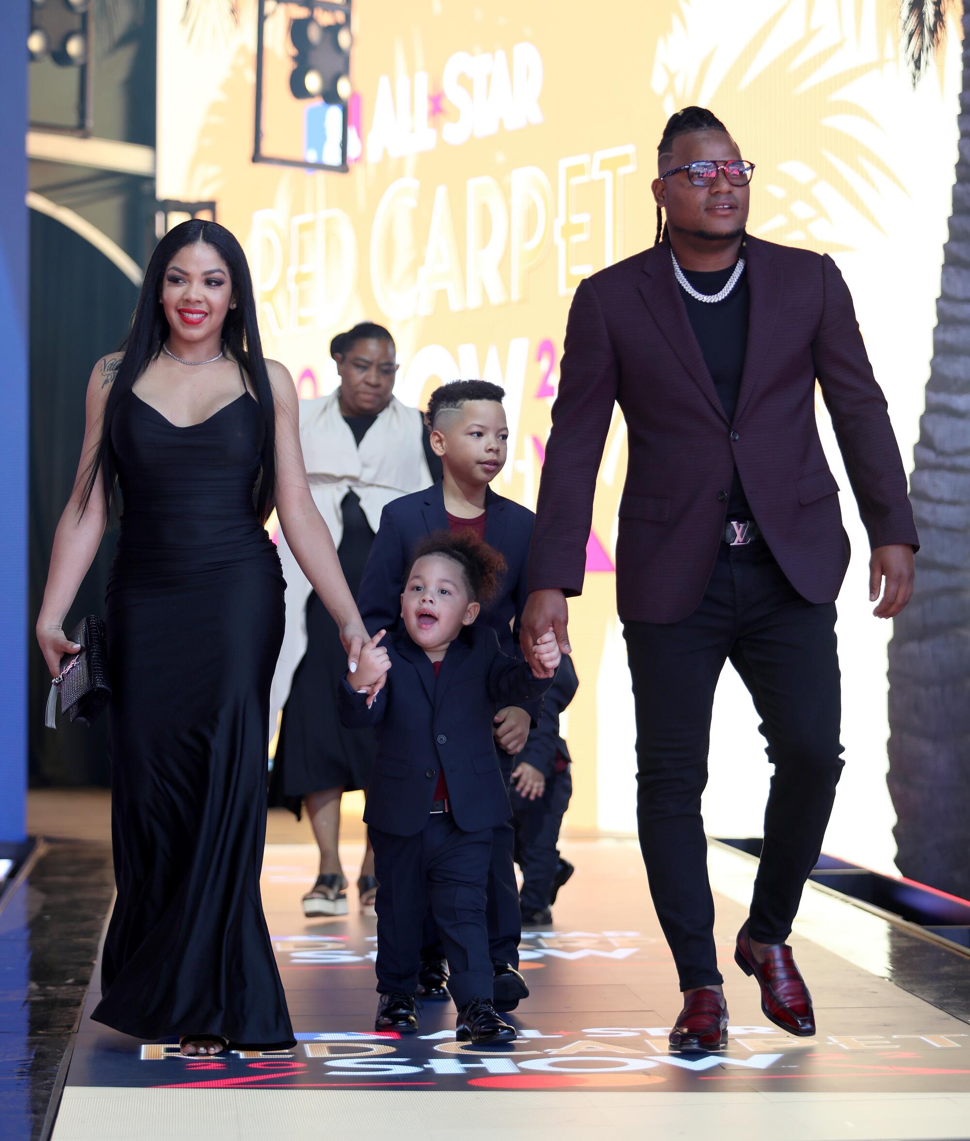 Framber Valdez in a purple and black suit and family arrive at the 2022 MLB All-Star Game Red Carpet Show.