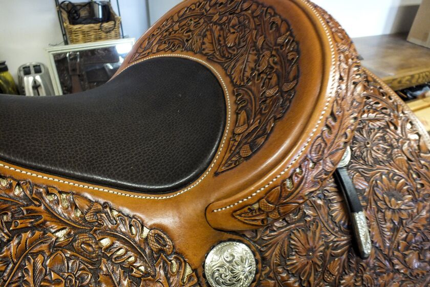 Using his leatherwork and silversmith skills, Pedro Pedrini creates fine saddles in his workshop at Hamley & Co., located along Pendleton's main drag.
