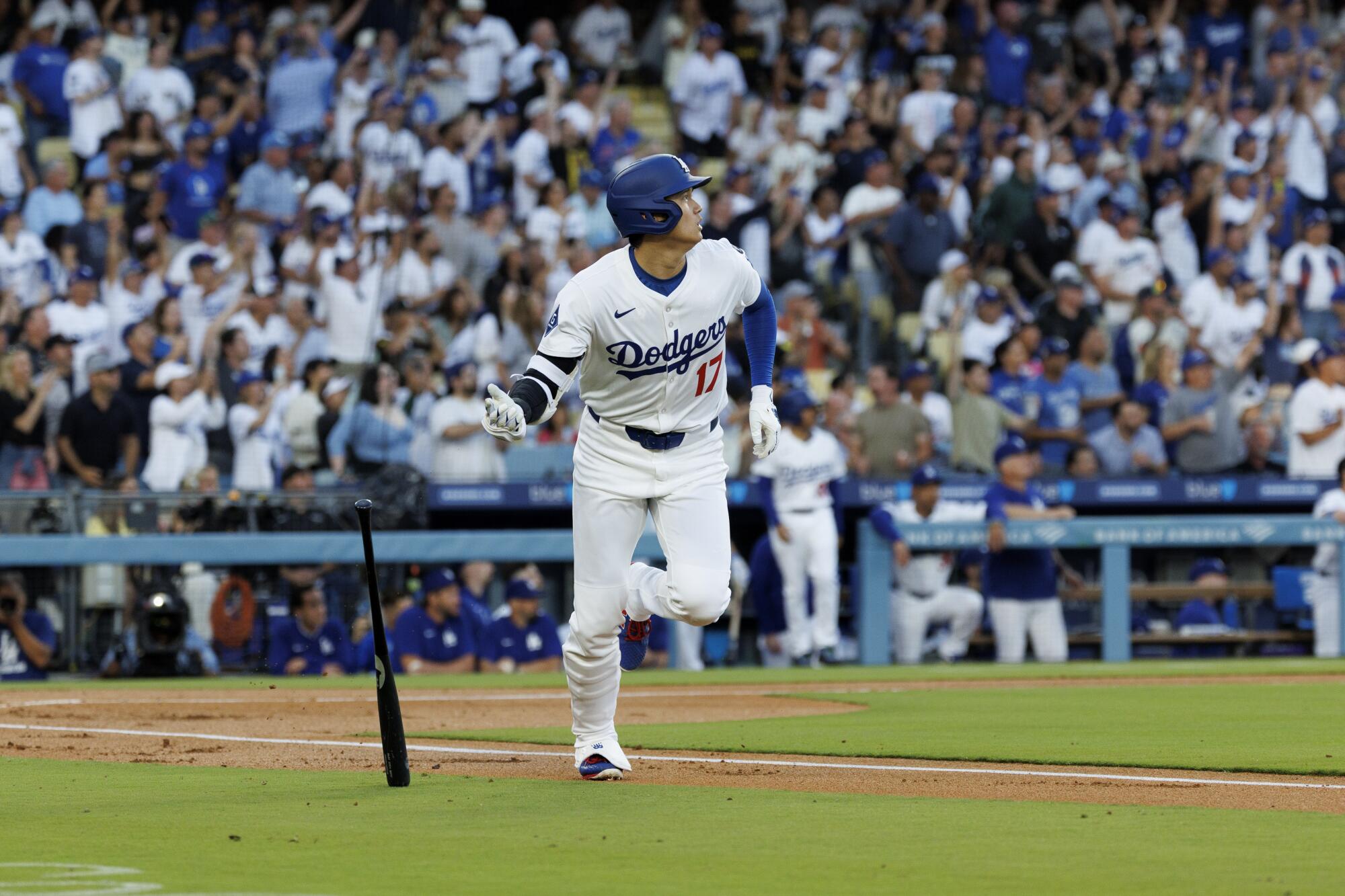 Dodgers star Shohei Ohtani flips his bat after hitting a solo home run in the first inning of an 8-5 win.