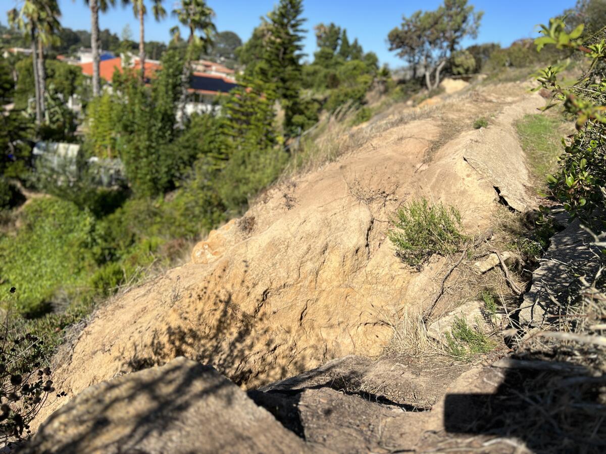 A broken concrete drainage ditch means water and mud run off onto the streets after a storm, resident Purushotham Kotha says.