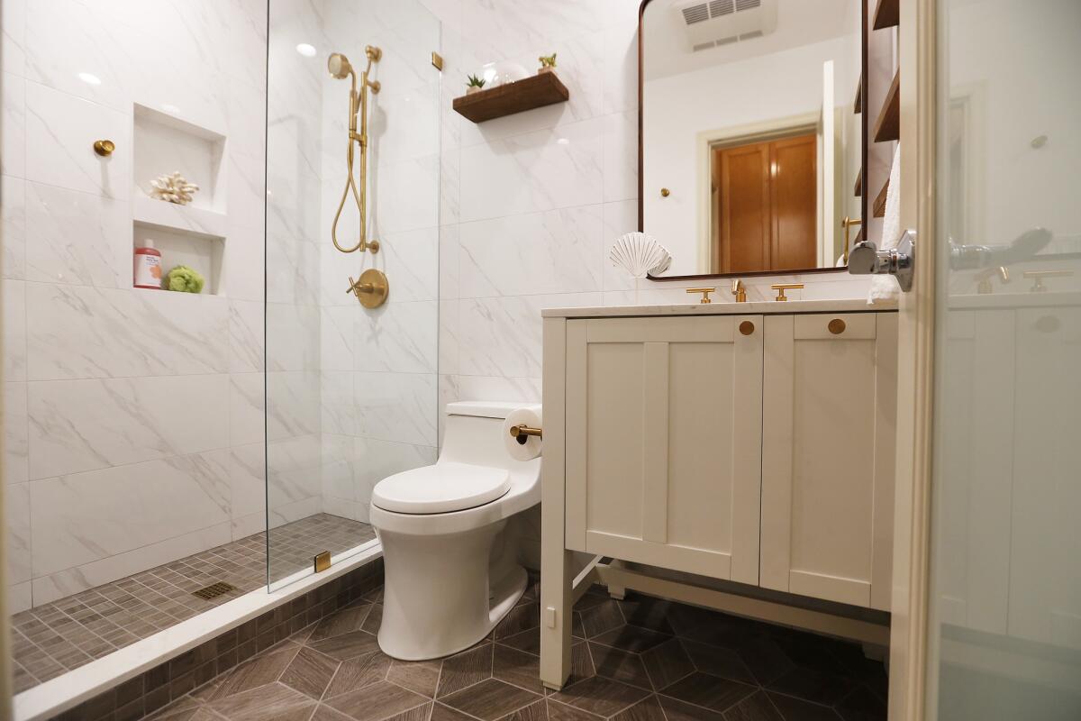 Ceramic tile flooring and small fixtures work well in the small bathroom renovated by designer Amalia Gal for Santa Monica homeowner Reva Choi.