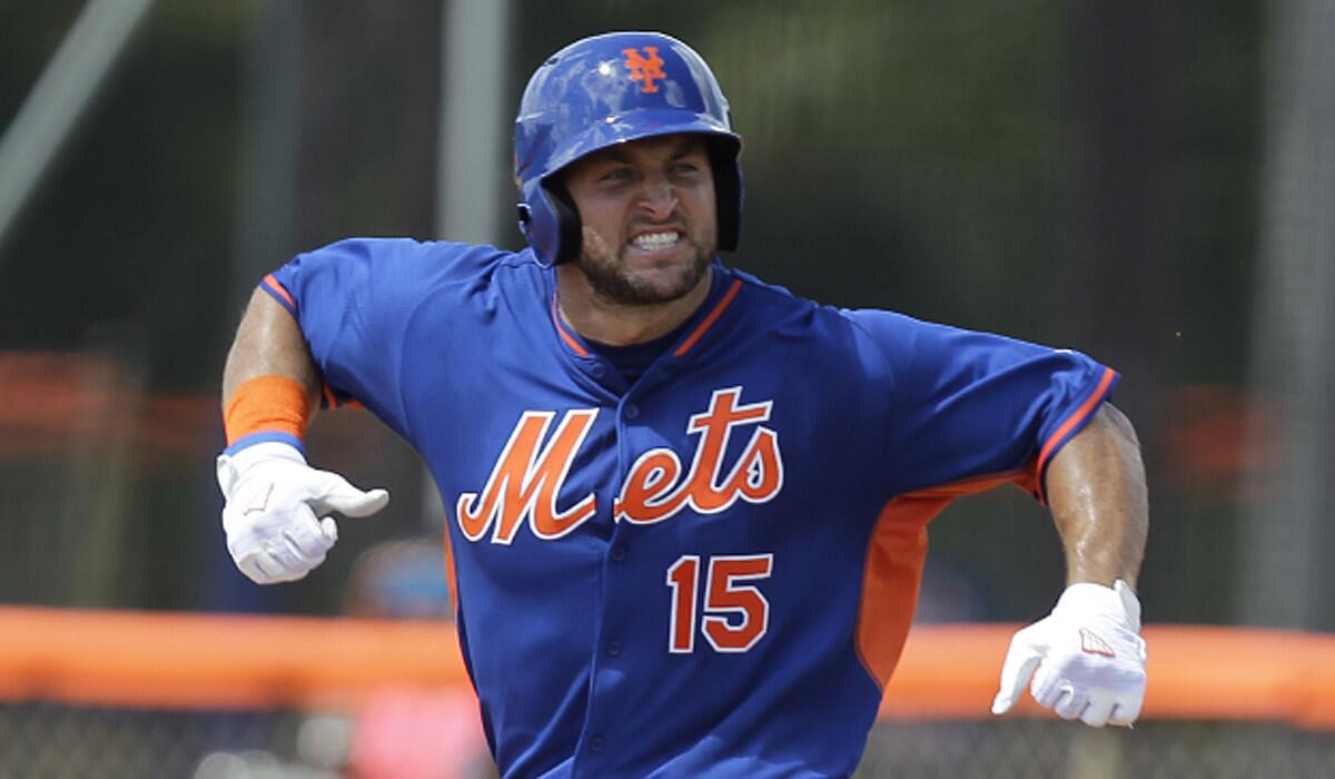 Tim Tebow reacts after hitting a solo home run Wednesday in his first at-bat during the first inning of his first instructional league baseball game.