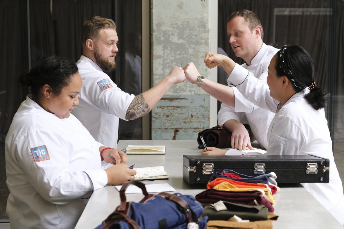 A team of "Top Chef" contestants celebrate after finishing a challenge