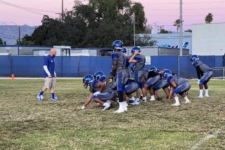 North Hollywood coach Scott Faer puts his team through the double wing.