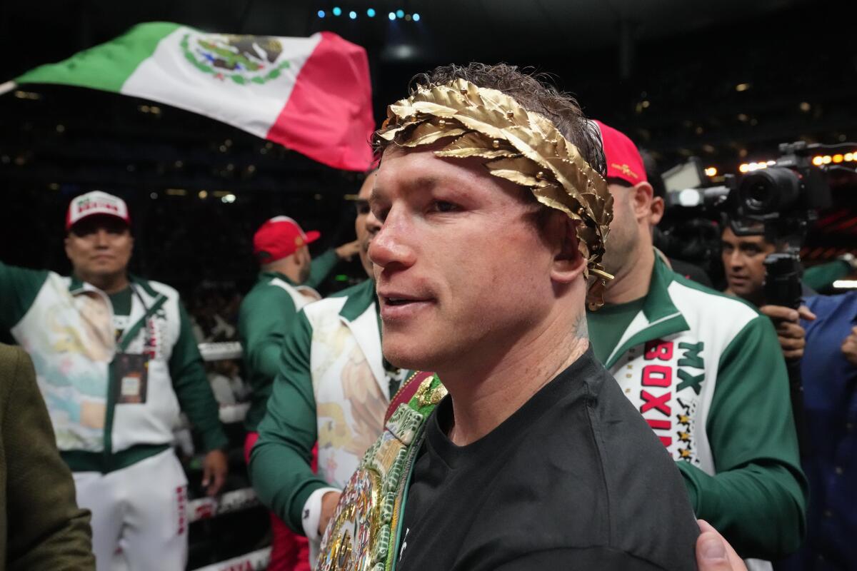 Canelo Alvarez celebrates after defeating John Ryder in their super middleweight title boxing match in Guadalajara