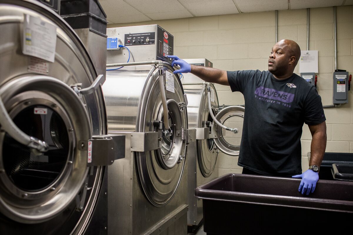 Fireman Avon Bryant, who works as a volunteer for the Baltimore Ravens, gets ready to unload a team washing machine.