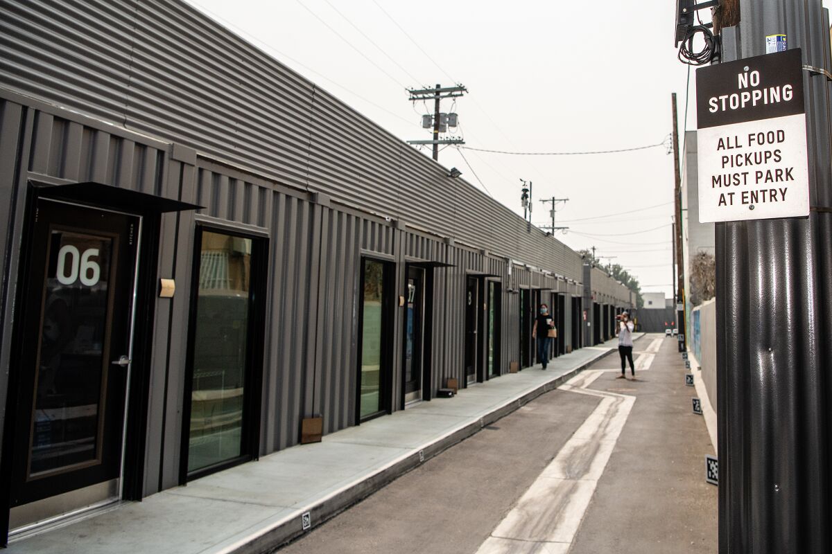 Rows of shipping containers were used to create the small kitchens inside the Grand Food Depot