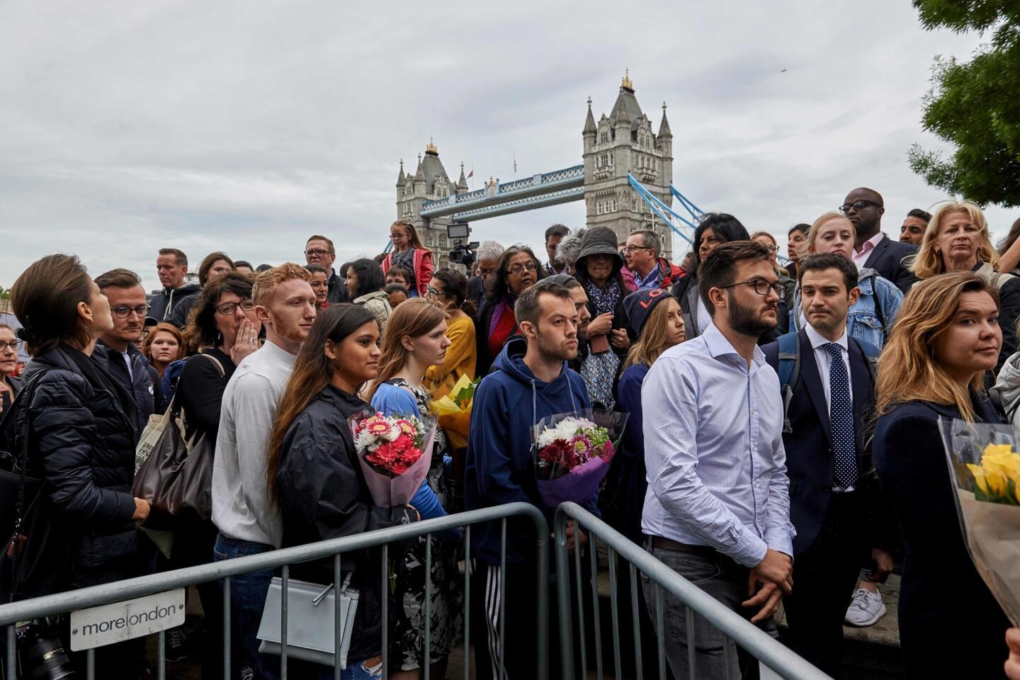People gather for a vigil at Potters Fields Park on Monday to commemorate the victims of the terrorist attack on London Bridge and at Borough Market.