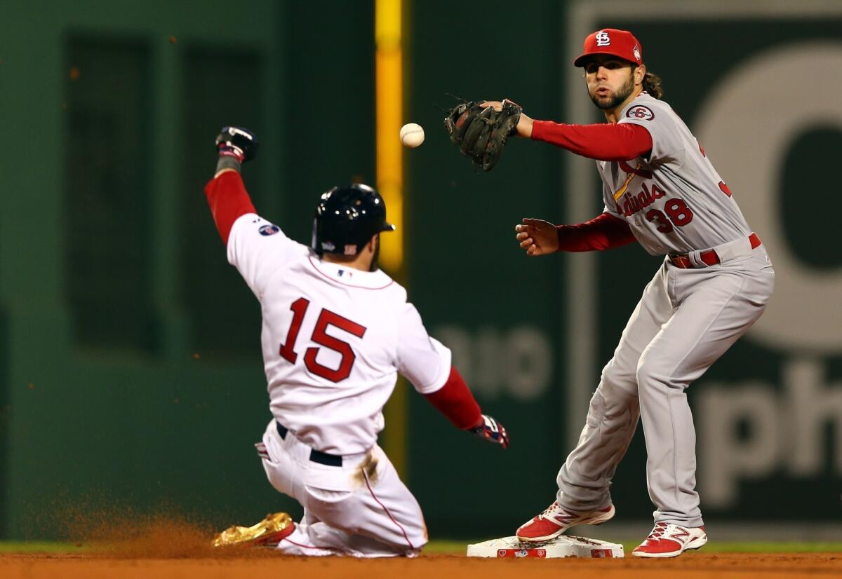 St. Louis' Pete Kozma drops the ball as the Red Sox's Dustin Pedroia slides into second base during Game 1 of the World Series on Wednesday.