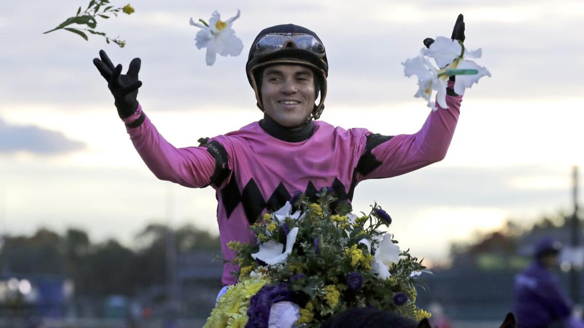 Joel Rosario celebrates after riding Game Winner to victory in the Breeders' Cup Juvenile horse race at Churchill Downs on Friday.