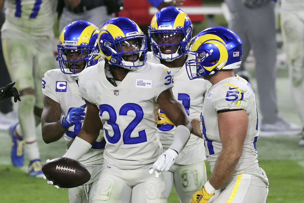 Rams strong safety Jordan Fuller celebrates with teammates after intercepting a pass by Buccaneers quarterback Tom Brady.