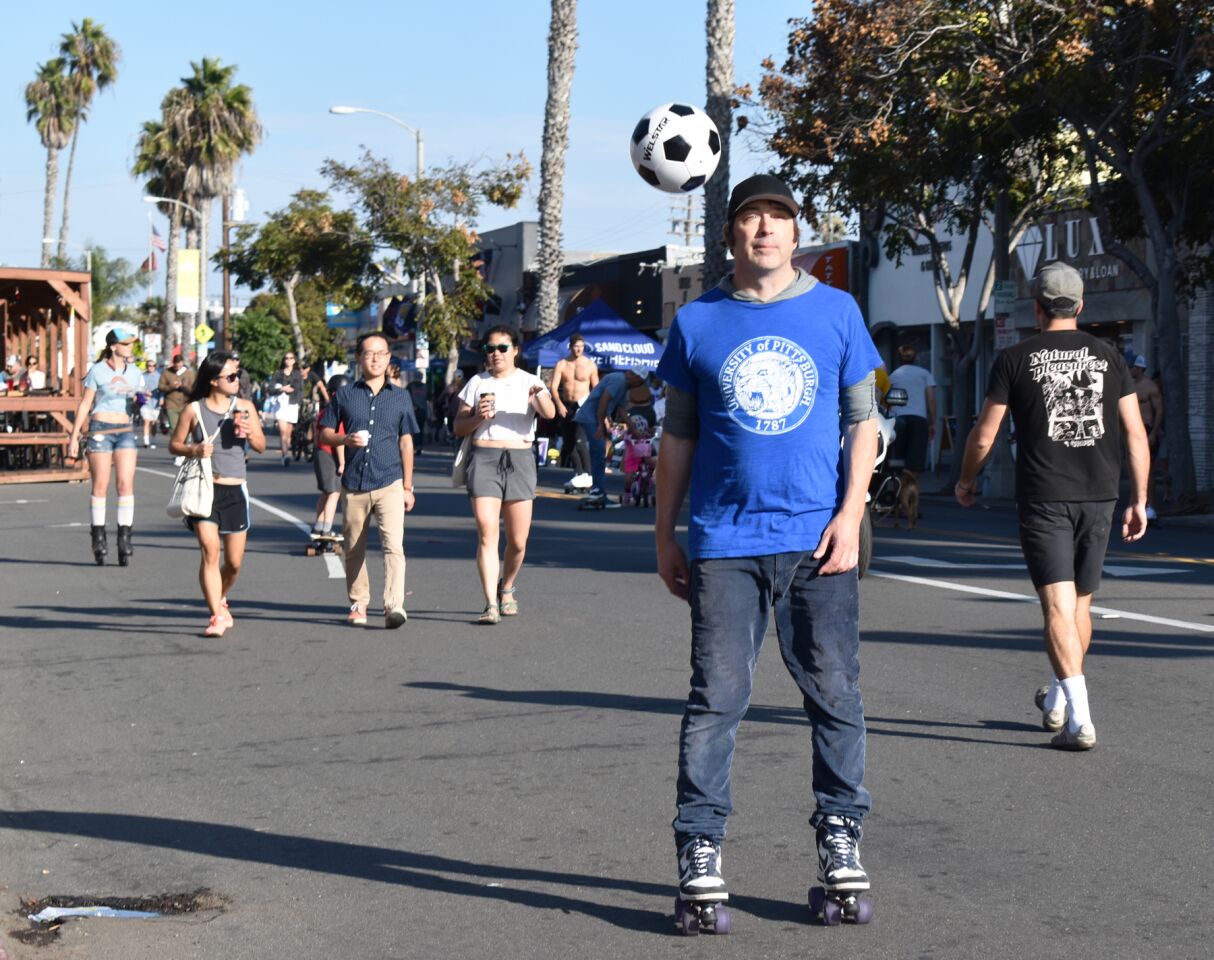 This roller skater bounced a soccer ball with his feet while other CicloSDias participants took a leisurely stroll.