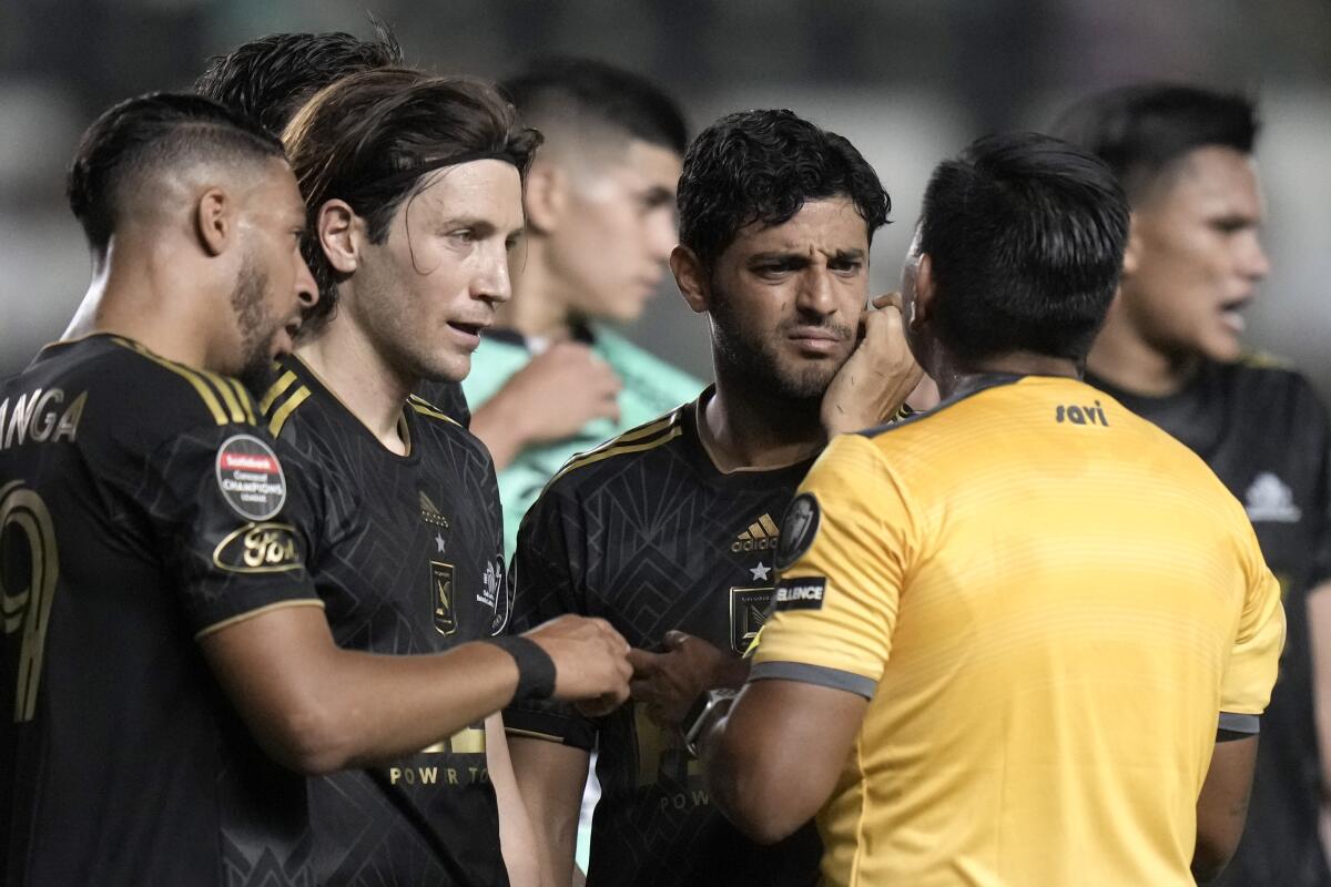 LAFC star Carlos Vela, right, listens to referee Walter Lopez during a loss to León.
