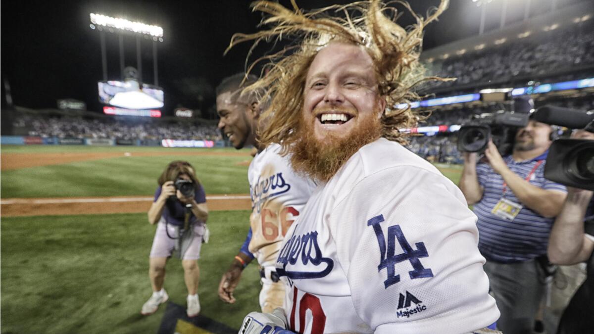 A jubilant Justin Turner celebrates after hitting a walk-off homer to beat the Cubs.