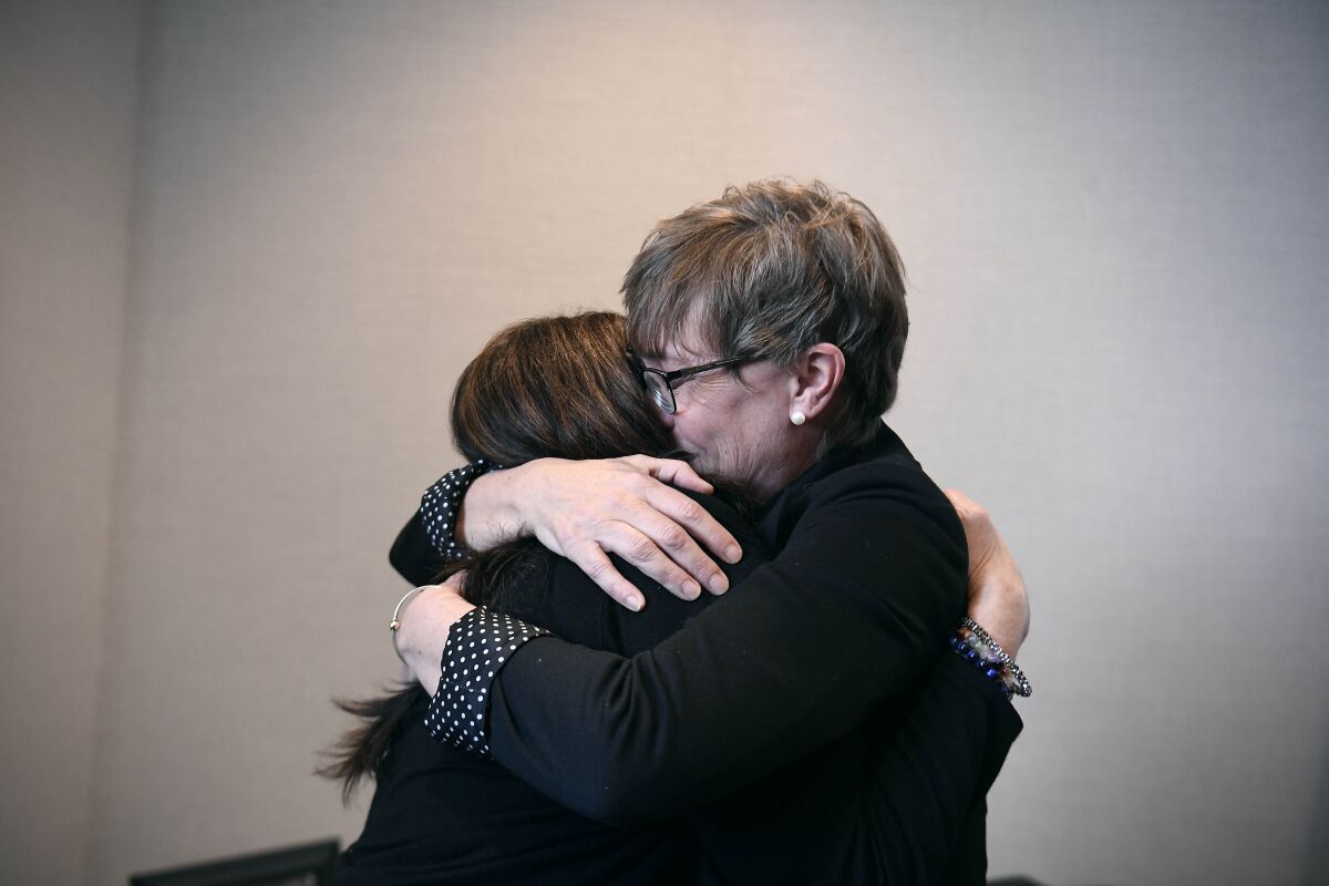 Liz Fitzgerald of Southington and Paige Niver of Manchester embrace at the end of a news conference at Connecticut Attorney General William Tong's office, Thursday, March 3, 2022, in Hartford, Conn. Fitzgerald lost two sons to opioids and Niver's daughter became addicted to opioids after getting prescribed OxyContin at 14 years old. (AP Photo/Jessica Hill)