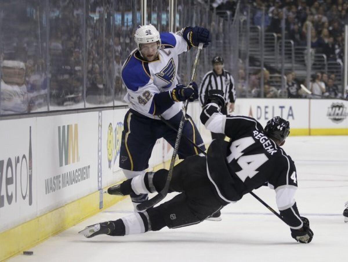 David Backes of St. Louis collides with Robyn Regehr of the Kings in Game 3.