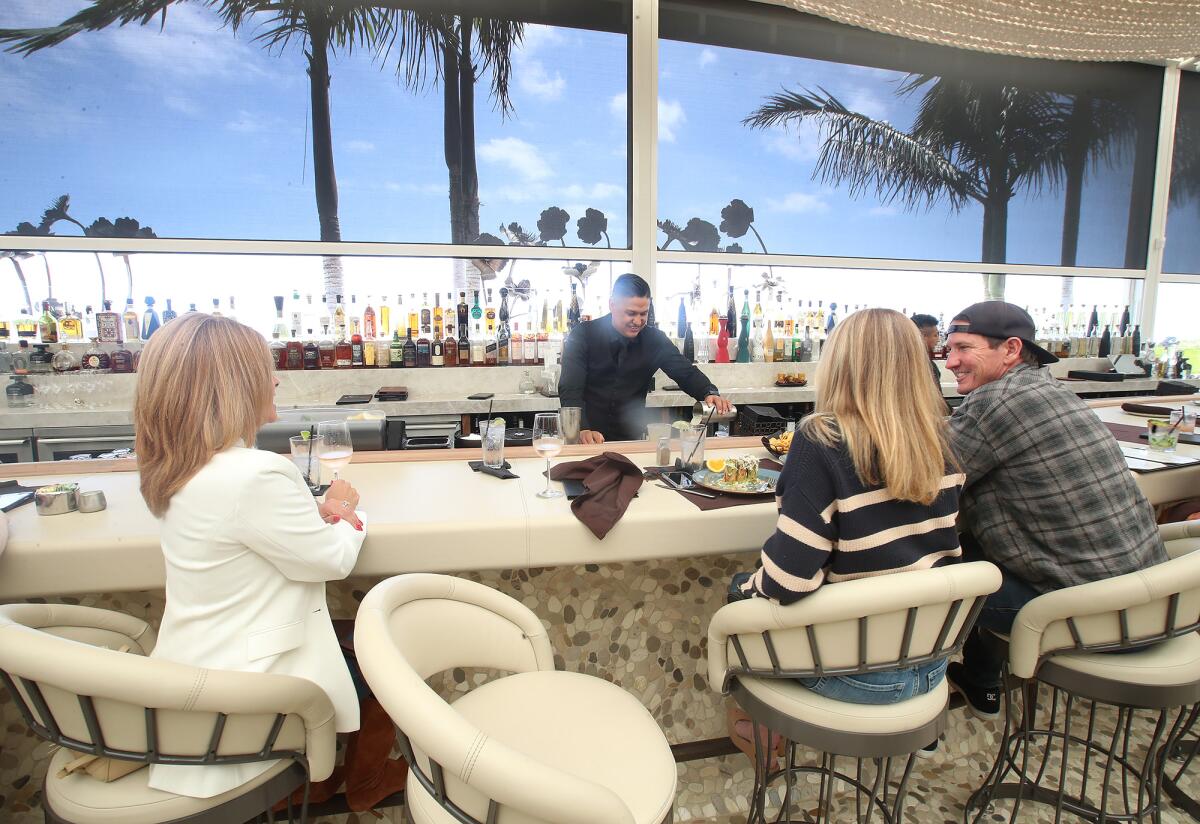 Guests enjoy the new bar space at the remodeled Javier's in Newport Beach.