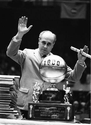 Red Auerbach gestures to fans during ceremonies honoring him at Boston Garden in 1966.