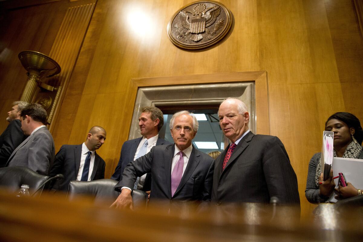 Senate Foreign Relations Committee Chairman Sen. Bob Corker (R-Tenn.), center, speaks with the committee's ranking member Sen. Ben Cardin (D-Md.) on April 14. A compromise between Congress and President Obama on Iran marks a rare moment of cooperation.