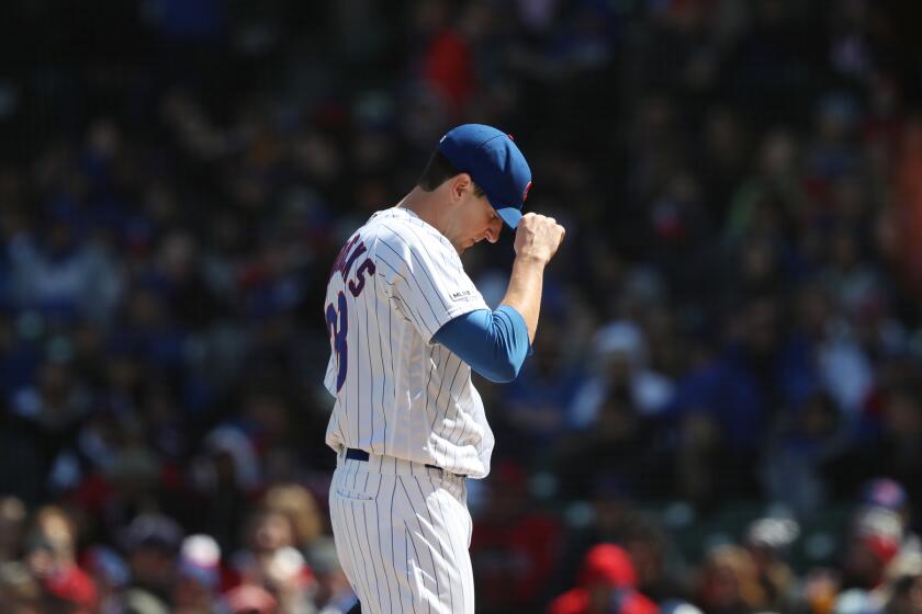 Cubs starting pitcher Kyle Hendricks adjusts his cap after loading the bases in the second inning against the Angels at Wrigley Field on April 13, 2019.
