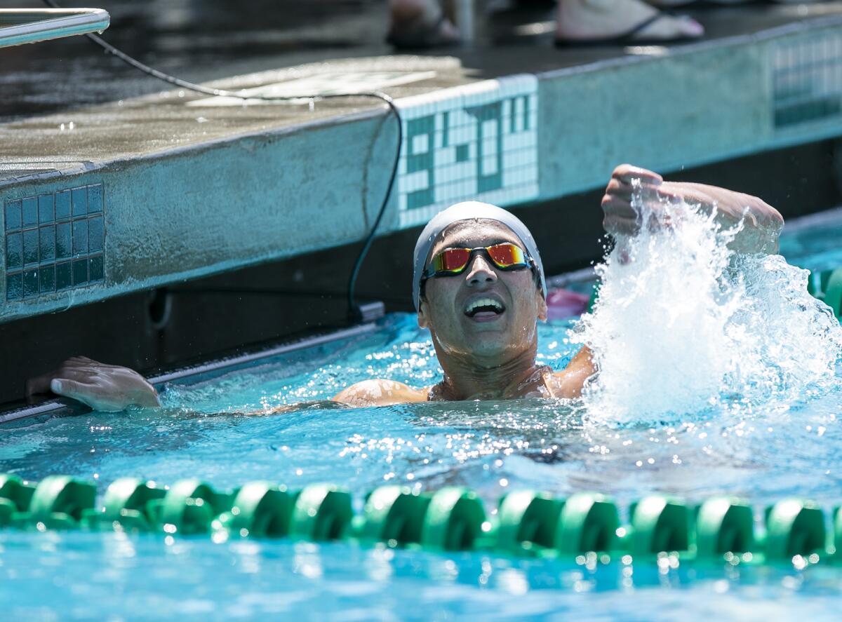 Newport Harbor's Aidan Arie celebrates winning the boys' 200-yard freestyle on Thursday.
