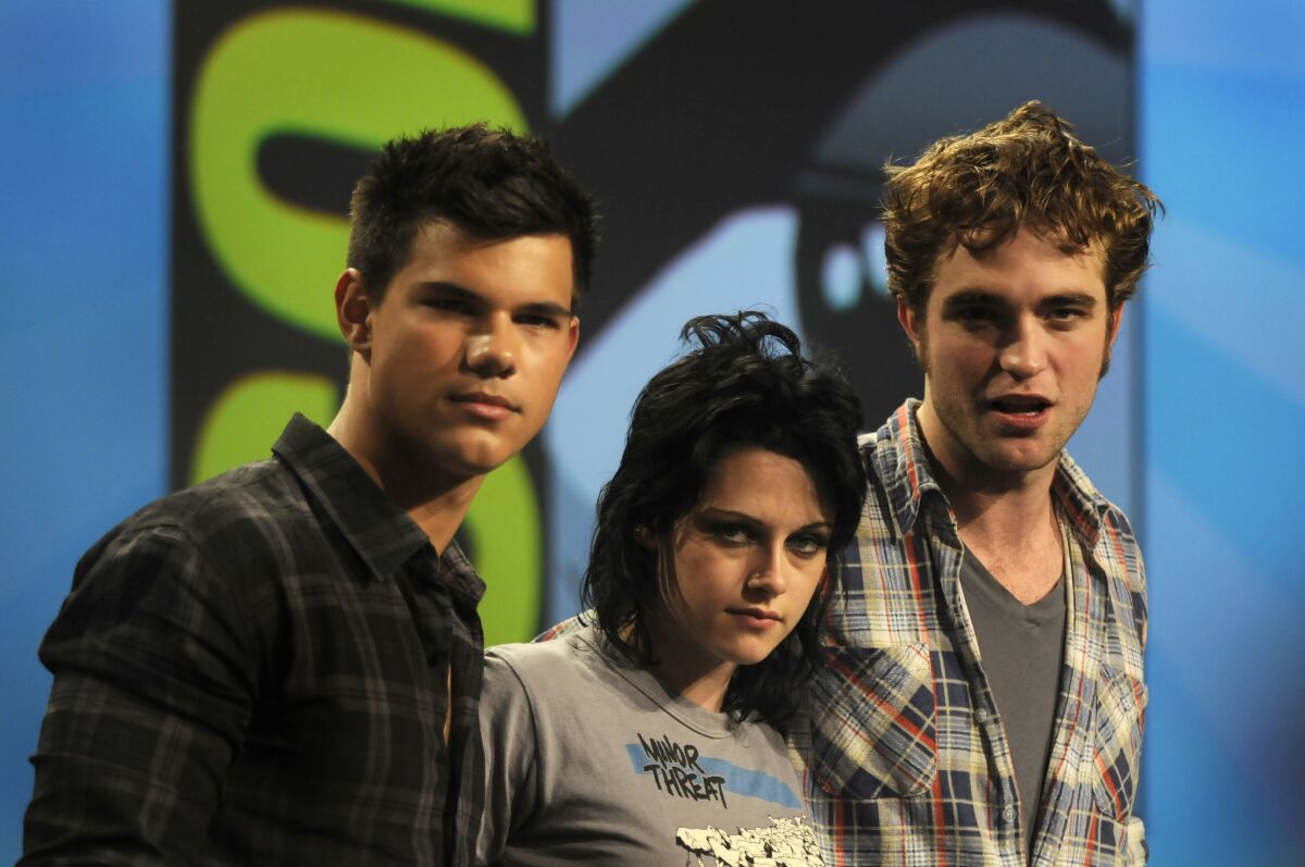 "Twilight" stars Taylor Lautner, left, Kristen Stewart and Robert Pattinson talk about "New Moon" in 2009.