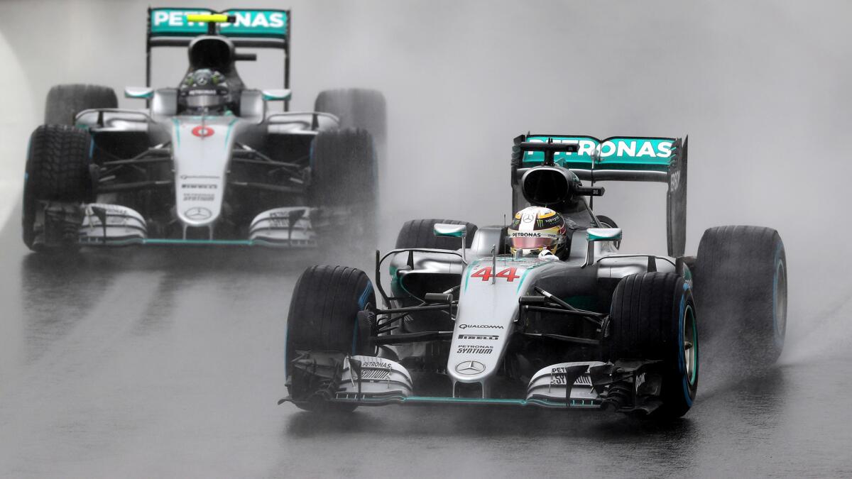 Formula One driver Lewis Hamilton (44) leads teammate Nico Rosberg during the rain-plagued Brazilian Grand Prix on Sunday.