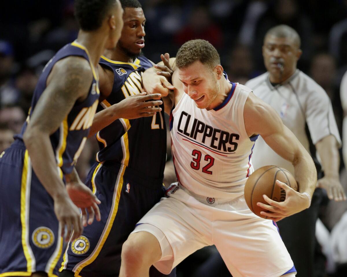 Clippers forward Blake Griffin, right, tries to get past Pacers forward Thaddeus Young, center, and guard Jeff Teague during the first half of Sunday's game.