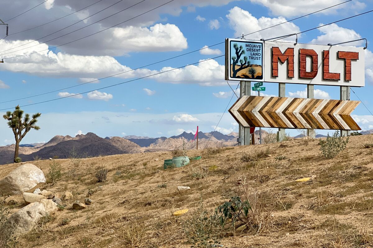 The bold red letters of the Mojave Desert Land Trust sign