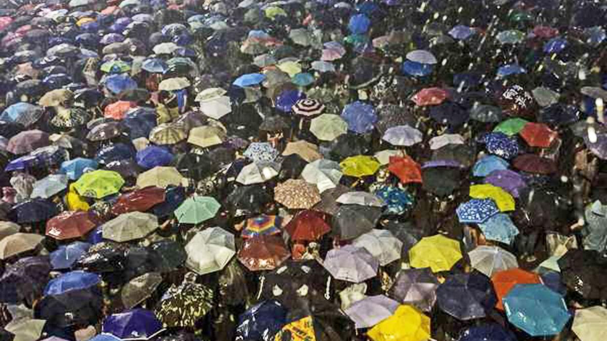 Pro-democracy protestors use umbrellas to shield themselves from heavy rain in Hong Kong on Sept. 30.