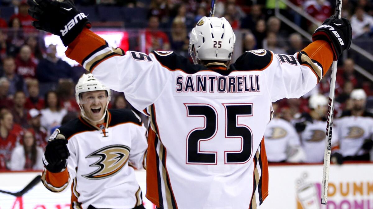 Ducks center Mike Santorelli (25) celebrates his goal against the Capitals with right wing Chris Wagner during the second period Sunday.