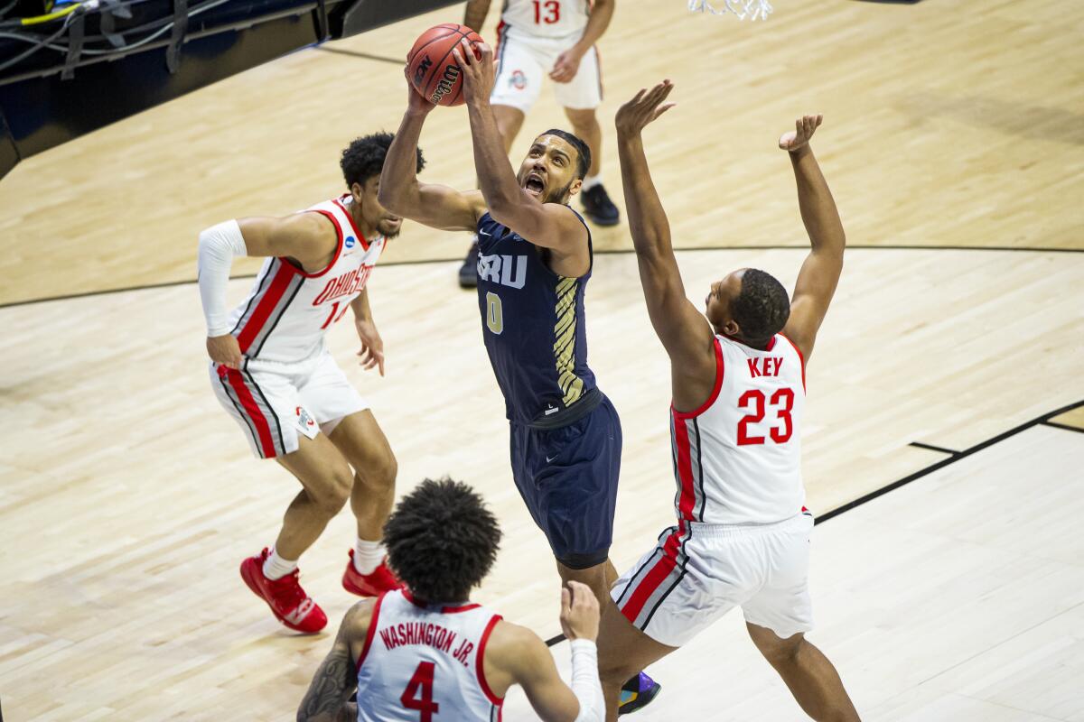 Oral Roberts' Kevin Obanor goes up for a shot between Ohio State's Justice Sueing, Duane Washington Jr. and Zed Key.