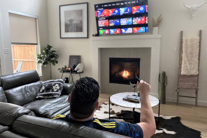 Eric Vieira checks out the streaming options on his smart TV.