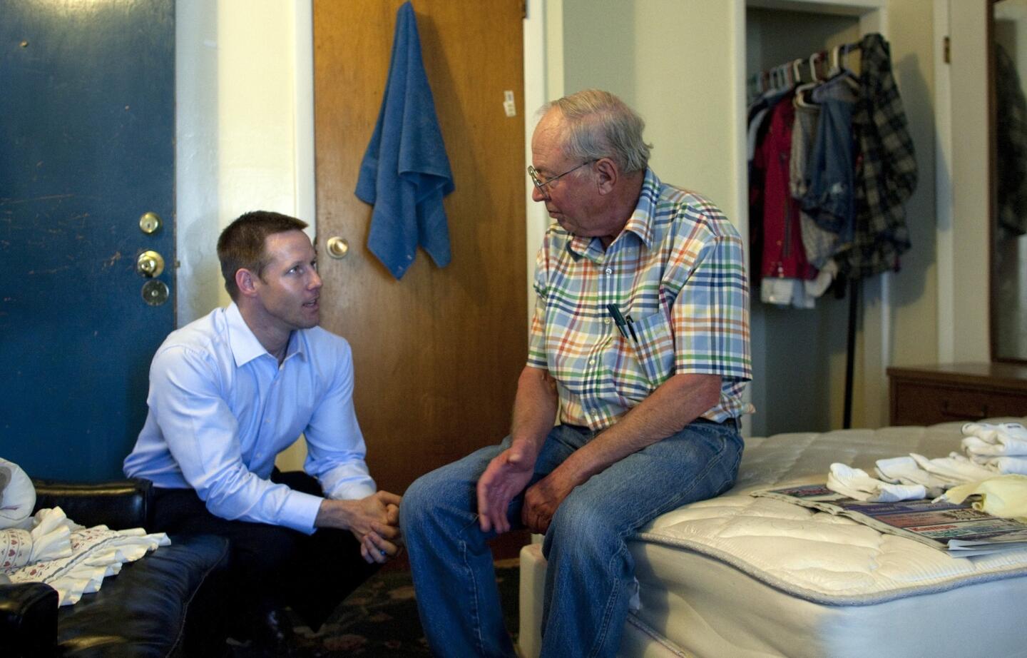 Art Moore, left, Republican challenger to Republican Rep. Tom McClintock, chats with fellow veteran James Mann at the Victory Village Amador, a facility for homeless vets, during a campaign stop in Jackson, Calif.
