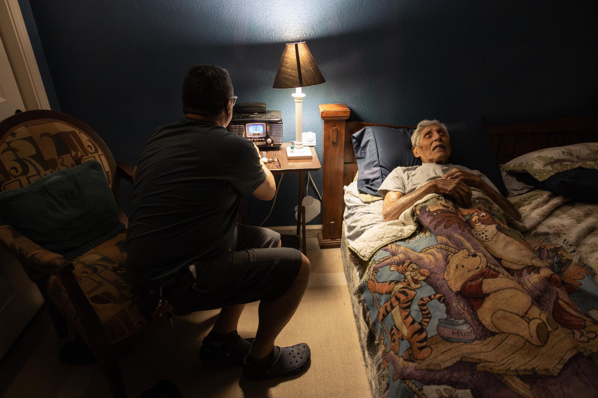 Joe Guthrie finds Frank Sinatra songs for his uncle, Bob Fernandez, as he puts him to bed.