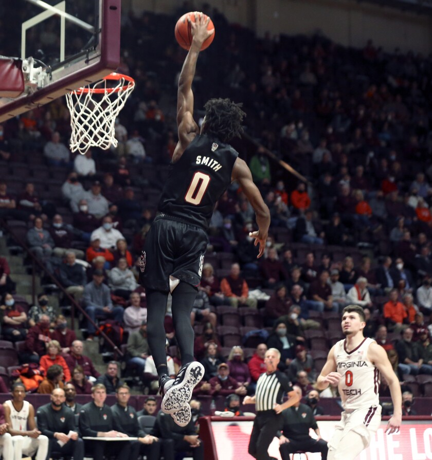 CORRECTS TO TERQUAVION SMITH, INSTEAD OF JERICOLE HELLEMS - North Carolina State's Terquavion Smith (0) scores against Virginia Tech during the first half of an NCAA college basketball game Tuesday, Jan. 4, 2022, in Blacksburg, Va. (Matt Gentry/The Roanoke Times via AP)