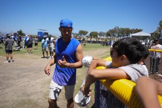 Rams quarterback Matthew Stafford signs autographs after a joint NFL practice with the Dallas Cowboys Wednesday.