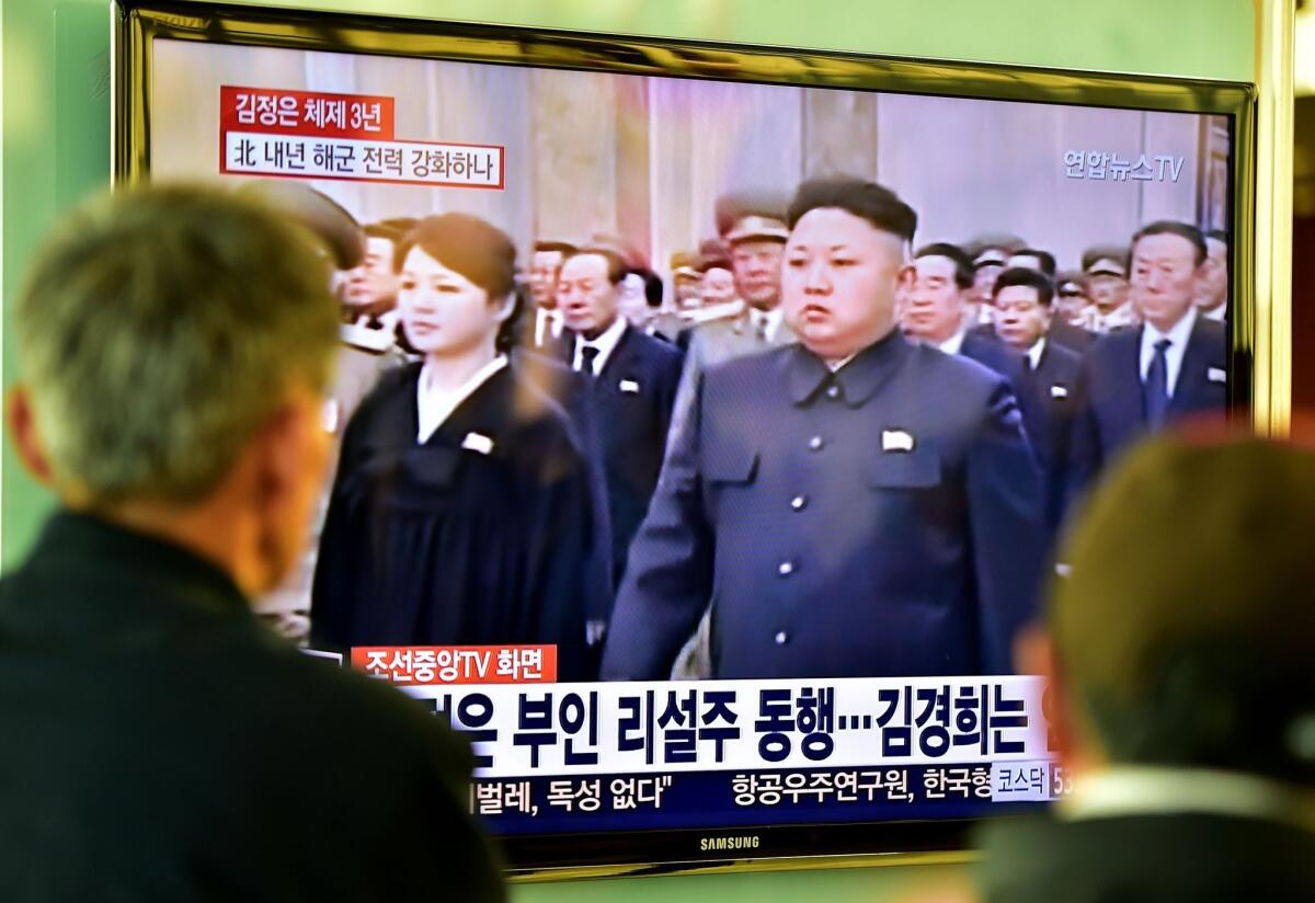 People at a railway station in Seoul watch TV images of North Korean leader Kim Jong Un attending a Dec. 17 ceremony marking the third anniversary of late leader Kim Jong Il's death.