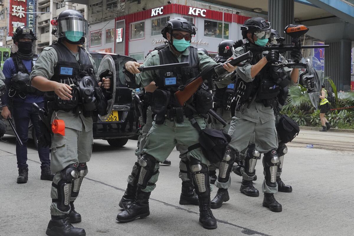 Hong Kong riot police fire tear gas at protesters on Sunday.