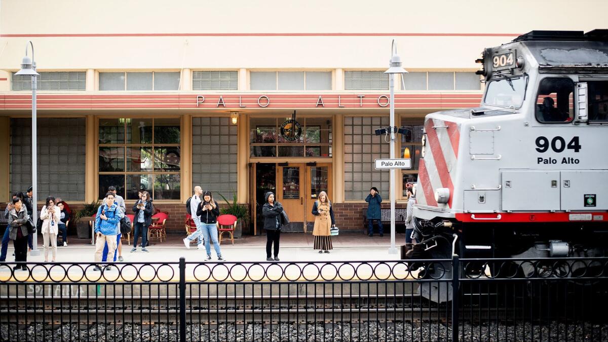 Commuters wait for a train at Caltrain's Palo Alto station. Senate Bill 50 would relax construction restrictions near mass transit, making higher-density housing possible near the station.