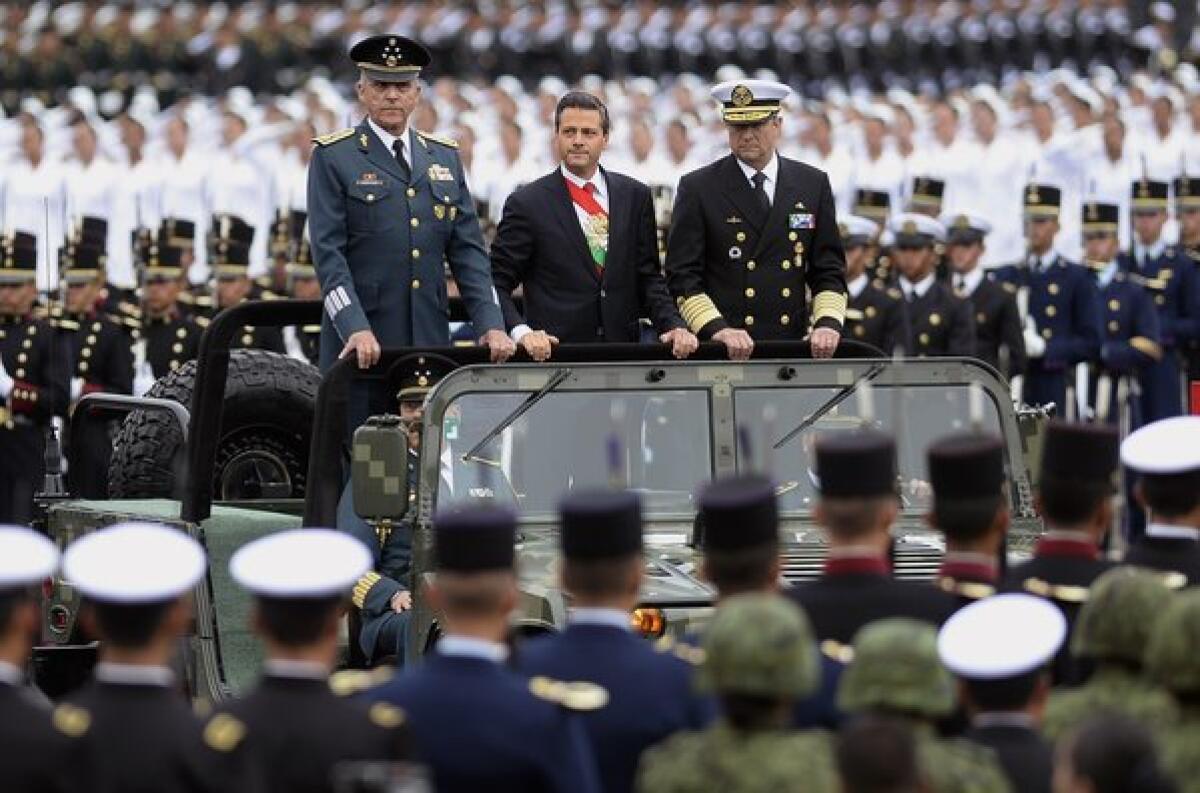 President Enrique Peña Nieto, center, shown last month during an Independence Day celebration, has vowed to rein in official corruption.