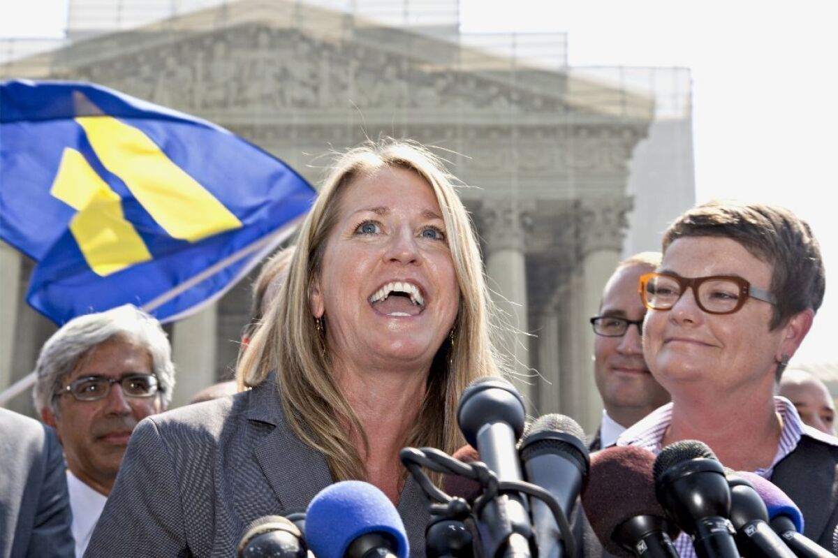 Sandy Stier, center, and her now-wife Kris Perry, right -- plaintiffs in Hollingsworth vs. Perry, the Proposition 8 case -- were married in San Francisco on Friday by Atty. Gen. Kamala Harris. Here, the couple reacts outside the Supreme Court in Washington after the court's 5-4 decision that cleared the way for the resumption of same-sex marriage in their home state of California.