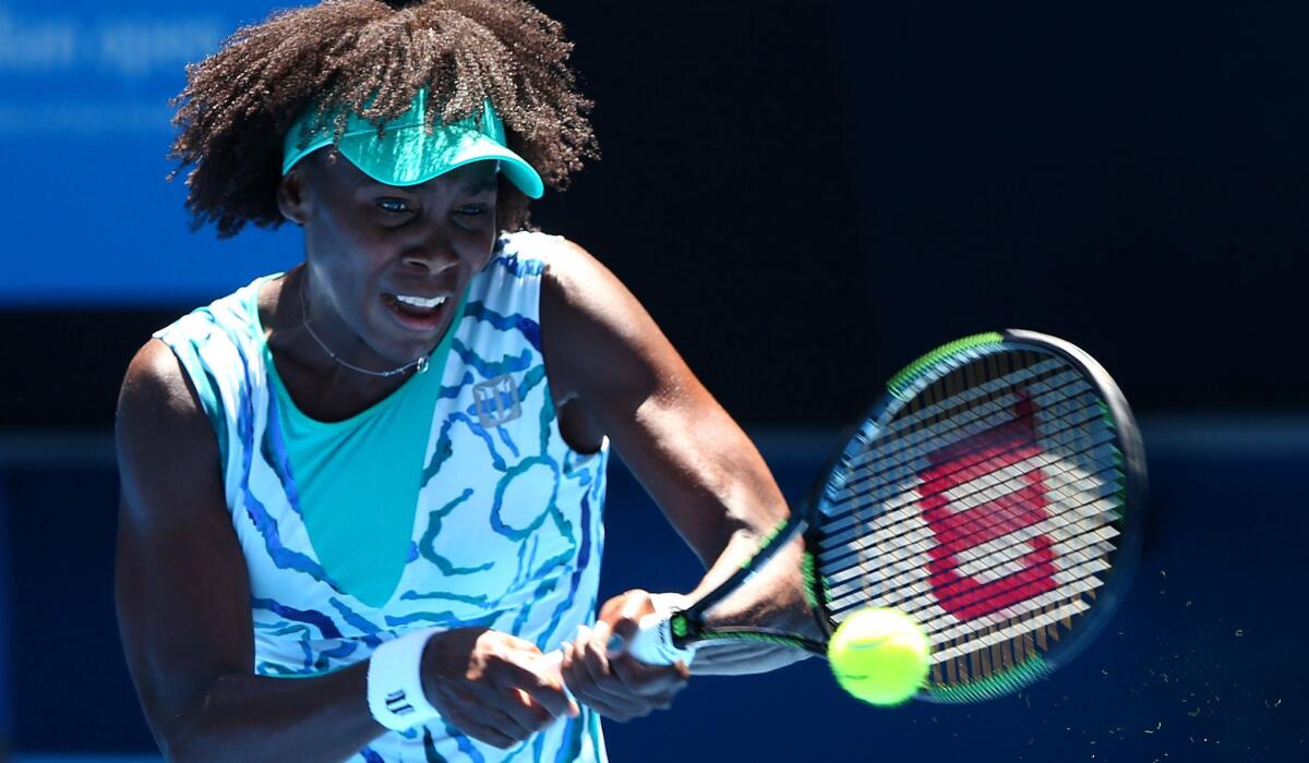 Venus Williams returns a shot against Camila Giorgi during their third-round match at the Australian Open on Saturday in Melbourne.
