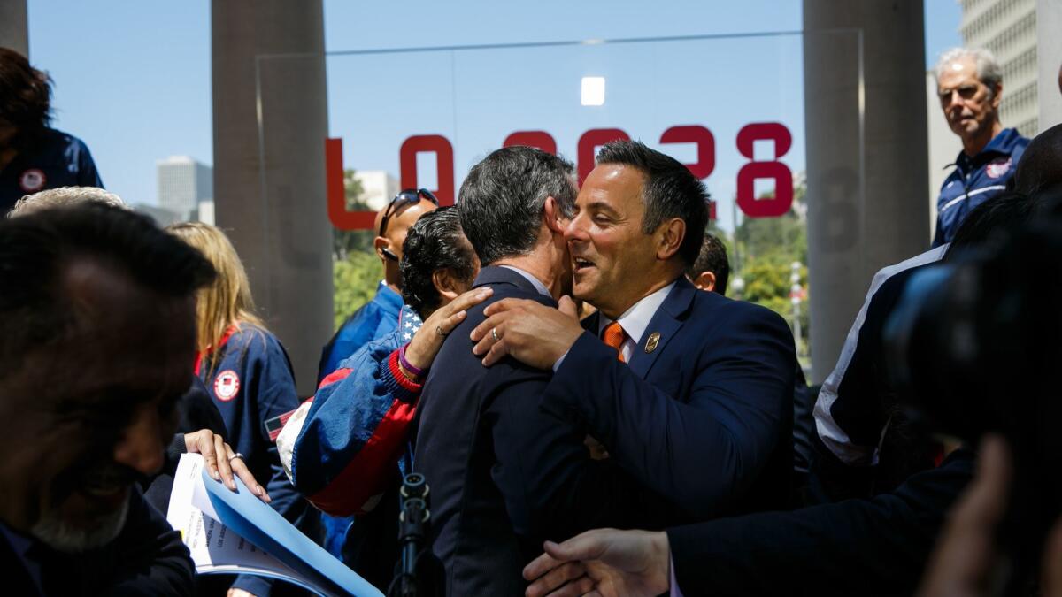 Mayor Eric Garcetti is congratulated by council member Joe Buscaino at a news conference Aug. 11, 2017, to announce the L.A. City Council vote in approval for Los Angeles hosting the 2028 Olympics.