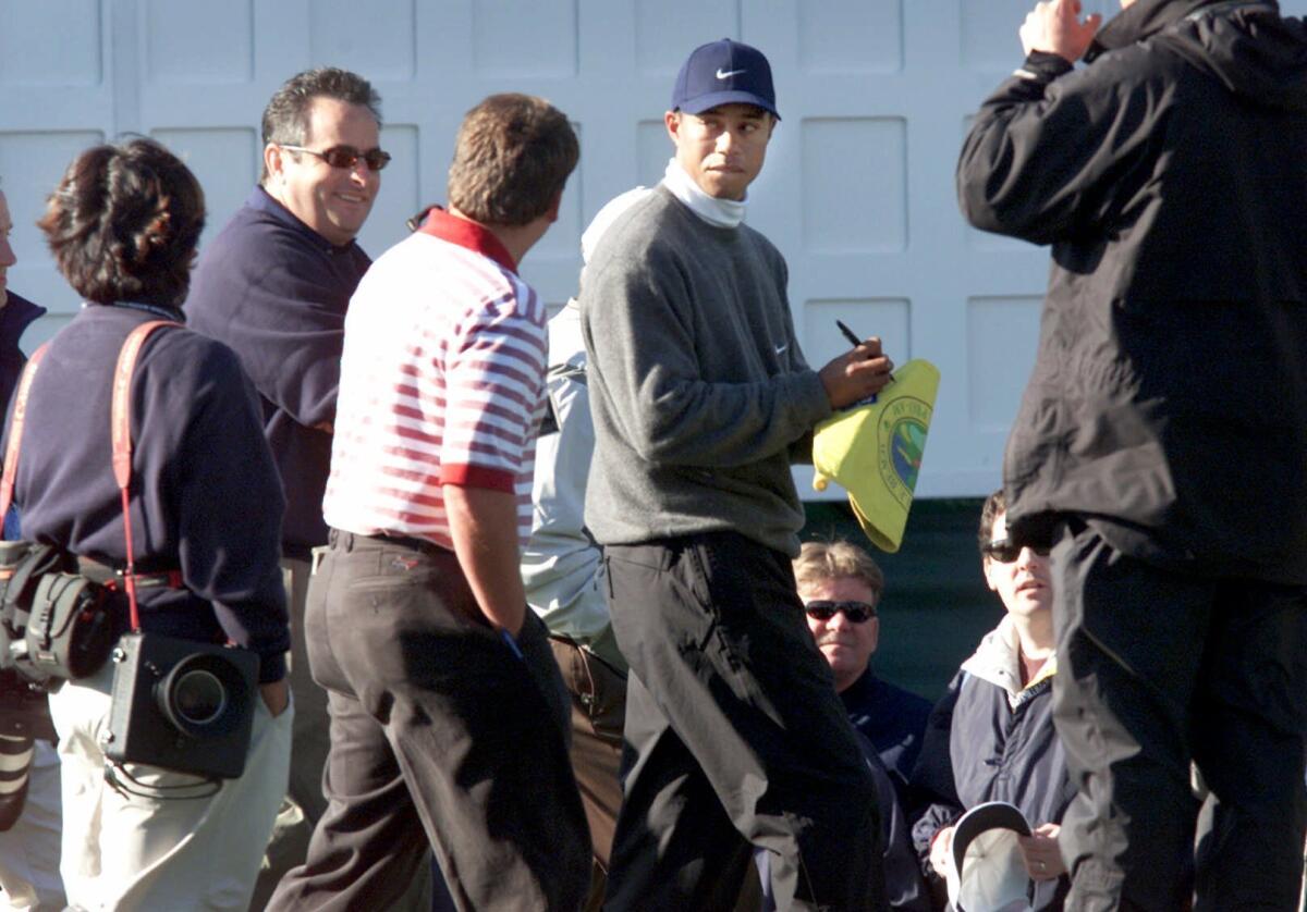Tiger Woods signs autographs at the Pebble Beach National Pro-Am on Jan. 31, 2001.