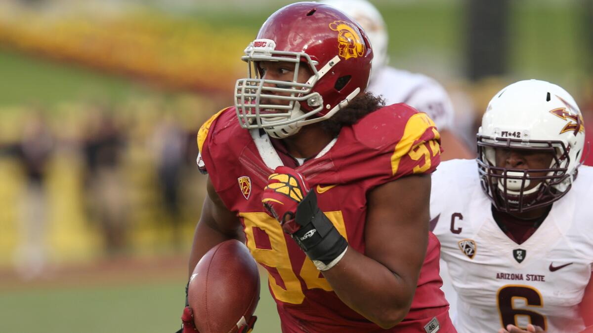 USC defensive tackle Leonard Williams returns an interception against Arizona State in November 2012. Williams says he isn't thinking about whether he'll leave USC early at the end of this season.