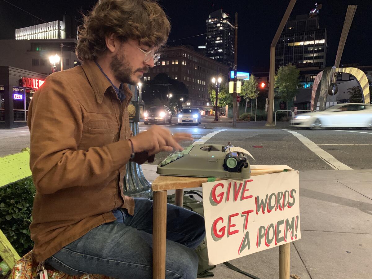 Street poet Ben Bernthal, 31, types a poem for a customer Tuesday on his Hermes Rocket typewriter in Portland, Ore., his latest hometown. 'It feels like there's something in the air shifting,' Bernthal said of the impeachment process starting. 'Or maybe it's just that I moved to Portland.'