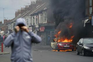 A car burns during an anti-immigration protest in Middlesbrough, England, Sunday Aug. 4, 2024. (Owen Humphreys/PA via AP)
