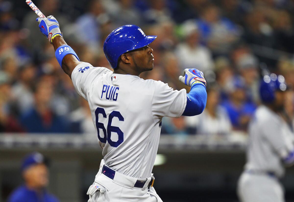 Dodgers outfielder Yasiel Puig hits a two-run triple in the fourth inning of a game against the Padres on April 5.